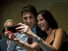 Liberal leader Justin Trudeau takes a photo with a supporter at a rally Friday, August 28, 2015 in Montreal. (THE CANADIAN PRESS)