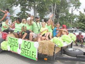 Members of the Steele family baseball team wave to the crowd during the 2014 Buxton Homecoming parade. The annual tradition is renewed again this weekend, Sept. 4-7.