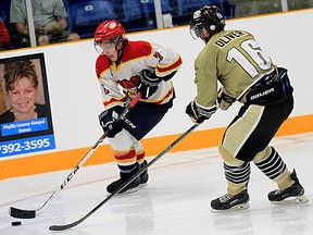 Wellington puckcarrier Trent Shutt is covered by Trenton defender Blayne Oliver during OJHL exhibition action Saturday in Trenton. (Emily Mountney/The Intelligencer)