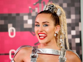 Singer and show host Miley Cyrus arrives at the 2015 MTV Video Music Awards in Los Angeles, California, August 30, 2015.  REUTERS/Danny Moloshok