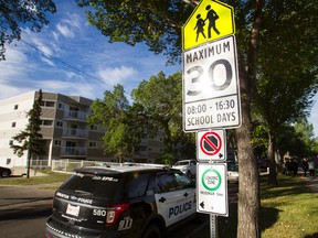 A police SUV is seen next to a school zone sign during a news conference reminding drivers to slow down around schools outside of Mother Teresa Catholic School in Edmonton, Alta., on Monday August 31, 2015. Over 36,000 tickets were written for traffic violations after Edmonton brought in school zones for last year's school year. Ian Kucerak/Edmonton Sun/Postmedia Network