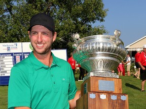 Brad Clapp of Chiliwack, B.C., holds the championship trophy after the final round of the Mackenzie Tour PGA Tour Canada Great Waterway Classic at the Loyalist Golf and Country Club in Bath on Sunday. (Ian MacAlpine/The Whig-Standard)