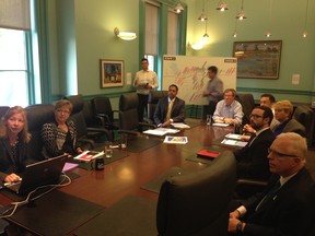Ottawa-area Tory candidates Pierre Poilievre and Dev Balkissoon sit flanking Mayor Jim Watson (head of table) at a briefing on local issues this morning at Ottawa City Hall. (Dani-elle Dube Ottawa Sun)
