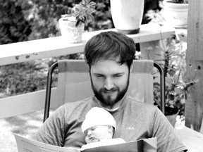 Chris Rumble reads to baby Sullivan.