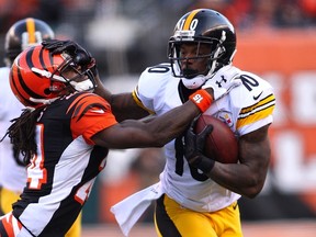 Martavis Bryant of the Pittsburgh Steelers stiff arms Adam Jones of the Cincinnati Bengals at Paul Brown Stadium in Cincinnati on December 7, 2014. (John Grieshop/Getty Images/AFP)