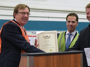 In February 2015, Tillsonburg Mayor Stephen Molnar (left) presented a certificate recognizing Siemens Canada's milestone of producing 1,000 blades at its Tillsonburg blade manufacturing facility. Receiving the certificate are Robert Hardt, President and CEO of Siemens Canada (centre) and plant manager Niels Kelter-Wesenberg. (CHRIS ABBOTT/FILE PHOTO)