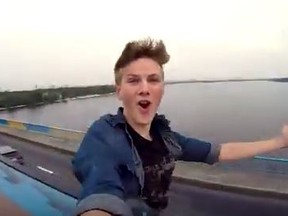 Pasha Bumchik took a video of himself jumping from a bridge onto a moving commuter train in Kiev. It's been watched on YouTube 1.3 million times since it was posted Saturday. (YouTube/Screen grab)