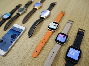 In this Aug. 21, 2015, Android Wear smartwatches compatible with the Apple iPhone are displayed at Google's offices in San Francisco.  (AP Photo/Eric Risberg)