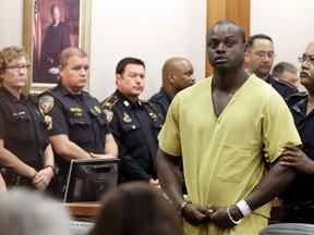 Shannon Miles is escorted out of a courtroom after a hearing, Monday, Aug. 31, 2015, in Houston. Miles has been charged with capital murder in the death of Harris County Sheriff's Deputy Darren Goforth. He is being held without bond. (AP Photo/Pat Sullivan)