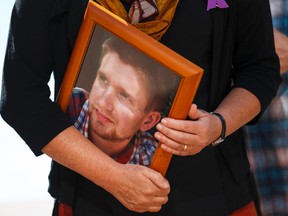 Petra Schulz holds a photo of her son Danny, 25, who died of an overdose during an International Overdose Awareness Day event held outside City Hall in Edmonton, Alta., on Monday August 31, 2015. Organizers advocate for more awareness, medical services and caring towards those struggling with drug use. Ian Kucerak/Edmonton Sun/Postmedia Network