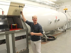 Mark Daymond, director of the new Queen's University reactor materials testing laboratory in Kingston, Ont., explains the workings of the lab's accelerator on Monday, Aug. 31, 2015. The lab will test the effect of such conditions as heat, stress and corrosion on materials inside a nuclear reactor. (Michael Lea/The Whig-Standard)