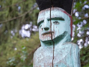 A totem pole stands at the back of the former Poole property on Fanshawe Park Road East in London, Ont. on Sunday August 30, 2015. (CRAIG GLOVER, The London Free Press)