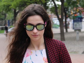 Caroline Budd, 21, returns to the Ottawa courthouse on Monday, Aug. 31, 2015 on the first day of her sex assault trial. She and Antonio "Anthony" Comunale, 32, are accused of assaulting two 16-year-old girls as sex slaves in May 2014.