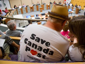 Supporters of door-to-door delivery sit in council chambers before the strategic priorities committee talk about mail delivery in London, Ont. on Monday August 31, 2015. (MIKE HENSEN, The London Free Press)