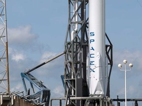 The unmanned SpaceX Falcon 9 rocket with the Dragon capsule waits for its launch to the International Space Station, on Launch Complex 40 at the Cape Canaveral Air Force Station in Cape Canaveral, Florida in this April 13, 2015 file photo. SpaceX plans to keep its Falcon 9 rocket grounded longer than planned following a launch accident involving the unmanned booster in June, the company president said on August 31, 2015.  REUTERS/Scott Audette/Files