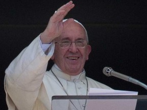 Pope Francis delivers his blessing as he celebrates the Angelus noon prayer from the window of his studio overlooking St. Peter's Square, at the Vatican,  Sunday, Aug. 30, 2015. (Andrew Medichini/AP Photos)