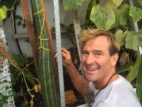 Daniel Tomelin poses for a photo with his 44.5-inch cucumber in this undated handout photo.  THE CANADIAN PRESS/HO-Daniel Tomelin