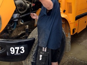 Scott Williamson, the head of bus maintenance at Murphy Bus Lines' depot in Mitchell, takes a final look under the hood of one of the many buses in the Mitchell fleet. GALEN SIMMONS/MITCHELL ADVOCATE