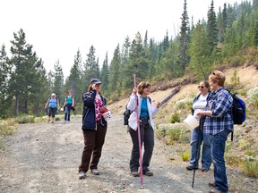 Eszter Thompson and her sister Marianna Orge exchange berry picking tips and stories with Shirley Smith and her daughter Nancy Bergmann, at the Castle Mountain Huckleberry festival on Aug. 29, 2015.