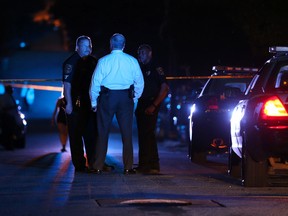 DeKalb County police officers work at the scene where an Atlanta-based officer was shot Monday evening, Aug. 31, 2015, five miles from Atlanta. (Ben Gray/Atlanta Journal-Constitution via AP)