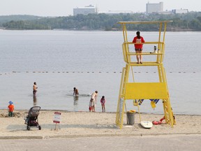 In this file photo, a lifeguard keeps a watchful eye on swimmers at the main beach at Bell Park on Aug. 31, 2015. Lifeguards will be on duty daily at six municipal beaches as of Saturday. (John Lappa/Sudbury Star)