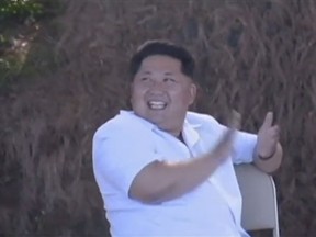 Kim Jong Un applauds a missile launch broadcast on North Korea's state TV. (Video screenshot)