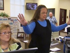 Rowan County Clerk Kim Davis gestures as she refuses to issue marriage licenses to a same-sex couple in Morehead, Kentucky September 1, 2015, in a still image from video provided by WLEX. Davis, defying a new U.S. Supreme Court decision and citing "God's authority," rejected requests for marriage licenses from same-sex couples on Tuesday in a deepening legal standoff now two months old. REUTERS/WLEX/LEX18.com