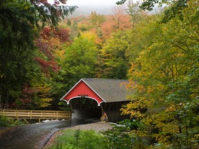 This Sept. 30, 2009 photo released by Gregory Keeler shows a covered bridge at Flume Gorge in the heart of New Hampshire’s White Mountain National Forest. The gorge is a good place to see fall foliage. (Gregory Keeler via AP)
