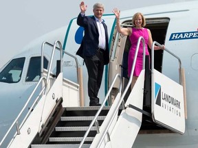 Conservative Leader Stephen Harper and his wife Laureen wave as they board the  party campaign plane after meeting the crew at the airport in Toronto,  Tuesday, September 1, 2015.  THE CANADIAN PRESS/Adrian Wyld