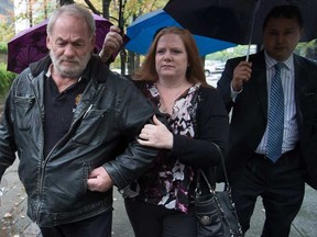 Ivan Henry, left, who was wrongfully convicted of sexual assault in 1983, and his daughter Tanya Olivares, centre, leave B.C. Supreme Court during a lunch break in Vancouver, B.C., on Monday August 31, 2015. Henry is suing prosecutors for allegedly breaching his charter rights after he was acquitted in 2010 of 10 sexual-assault convictions. THE CANADIAN PRESS/Darryl Dyck