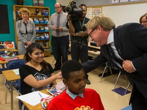 Alberta Education Minister David Eggen (left) meets Grade 8 student Himia Asif, 14, during a visit to St. Catherine Catholic School in Edmonton, Alta., on Tuesday September 1, 2015. The minister, during a later news conference, answered questions about school construction, the provincial budget and restored educational funding. Ian Kucerak/Edmonton Sun/Postmedia Network