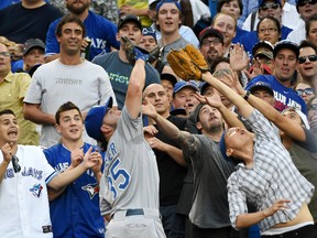 Kansas City Royal Eric Hosmer battles with fans as he catches a pop foul hit by Toronto Blue Jay Danny Valencia (not pictured) in the first inning at Rogers Centre in Toronto on July 30, 2015. (Dan Hamilton/USA TODAY Sports)