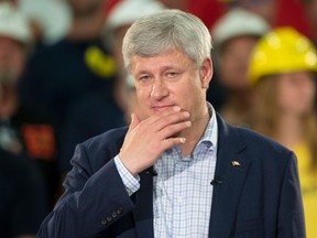 Conservative leader Stephen Harper listens to a question from the media during a campaign stop at a steel manufacturer in Burlington, Ont., on Tuesday, September 1, 2015. THE CANADIAN PRESS/Adrian Wyld