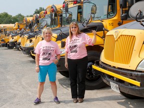 School bus drivers Penny Hughson, left, and Kim Clark are looking forward to the start of school next week. (Julia McKay/The Whig-Standard)