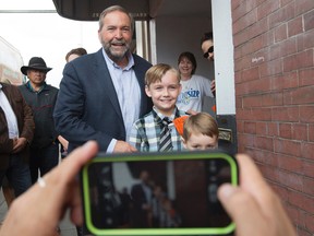 NDP Leader Tom Mulcair stops to get his picture taken during a federal election campaign stop in Vernon, B.C. Tuesday, Sept, 1 2015.   THE CANADIAN PRESS/Jonathan Hayward