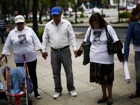 Relatives of missing persons pray in a demonstration to demand justice for their relatives during the International Day of the Victims of Enforced Disappearances in Mexico City, August 30, 2015. According local media, the U.N office for the Human Rights in Mexico, said that the country is in a critical situation on missing persons and called to Mexican state to take into consideration the opinions and experiences of the families of the victims of enforced disappearance and social organizations. The apparent massacre of 43 students in September of 2014 became a symbol of impunity over disappearances and plunged to President Pena Nieto into his deepest crisis. REUTERS/Edgard Garrido