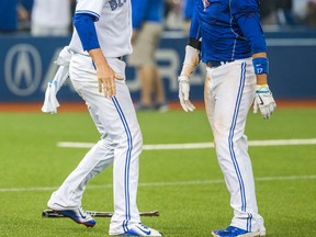 Blue Jays second baseman Ryan Goins (right) celebrates his two-run home run in the 10th inning with pitcher Mark Lowe as the Jays defeated the Indians 5-3 on Tuesday, Sept. 1, 2015. (Ernest Doroszuk/Toronto Sun)