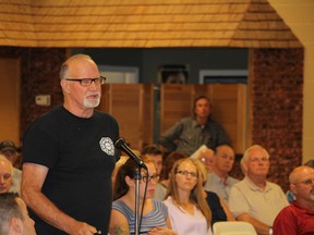 Mike Farlow asked a number of questions at the public meeting, calling into question the use of averages to show safe levels of particles in the air. (MEGAN STACEY/Sentinel-Review)