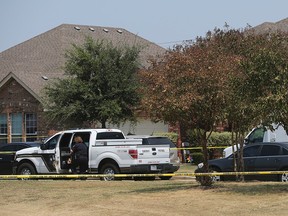 In this photo taken Aug. 28, 2015, the Bexar County Sheriff's Department investigates the scene where deputies shot a man as they responded to a domestic disturbance call in Northwest Bexar County, Texas, near San Antonio. (John Davenport/The San Antonio Express-News via AP)