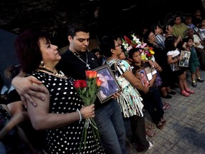 Relatives and friends of victims of an arson attack on the Casino Royale observe a minute of silence as they mark the fourth anniversary of the incident in Monterrey, Mexico, August 25, 2015. Gunmen of the Zetas drug cartel attacked the Casino Royale on August 25, 2011, killing 52 people in Nuevo Leon's capital Monterrey, according to local media. REUTERS/Daniel Becerril