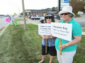 More than a dozen people held signs on Christina Street outside of Sarnia-Lambton MPP Bob Bailey's office for an hour on Wednesday September 2, 2015 in Sarnia, Ont., to protest Ontario's new sex education curriculum. Bailey, a Conservative member of the legislature, said he shares their concerns. (Paul Morden, The Observer)