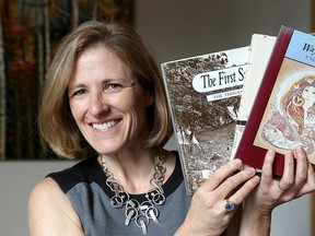 Elizabeth Turcke, head of school for Leahurst College in Kingston, holds some donated books from the estate of former member of Parliament Flora MacDonald. (Ian MacAlpine/The Whig-Standard)