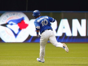 Toronto Blue Jays Edwin Encarnacion rounds the bases after hitting a grand slam in the seventh inning against the Detroit Tigers at the Rogers Centre in Toronto Saturday August 29, 2015. (Jack Boland/Toronto Sun)