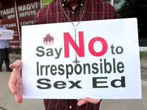 About a dozen people protested in front of MPP Yasir Naqvi's office in Ottawa Wednesday Sept 2, 2015. The small group were protesting the sex-ed curriculum in Ontario schools. Tony Caldwell/Ottawa Sun/Postmedia Network