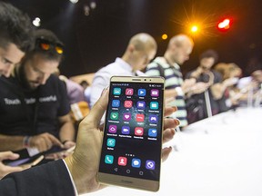 Journalists inspect the new smartphone Huawei Mate S ahead the of the IFA Electronics show in Berlin, Germany, Sept. 2, 2015. REUTERS/Hannibal Hanschke