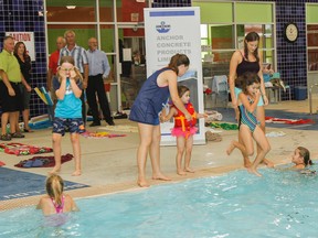Members of the Boys and Girls Club of Kingston and Area celebrate the Anchor Concrete Products Ltd donation of  $10,000 with a jump in the pool at the clubs west end hub pool in Kingston, Ont. on Wednesday September 2, 2015. Julia McKay/The Kingston Whig-Standard/Postmedia Network
