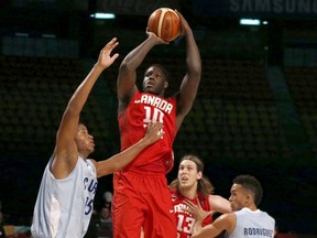 Canada's Anthony Bennett (10) goes for the basket against Cuba's Jasiel Rivero (left) and Yaser Rodroguez (right) as Canada's Kelly Olynyk (13) looks on during their FIBA Americas Championship game in Mexico City on Wednesday, Sept. 2, 2015. (Henry Romero/Reuters)