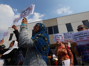 Protesters opposing the new school sex education curriculum gather out front of MPP Harinder Takhar's office in Mississauga on Wednesday Sept. 2, 2015.(DAVE ABEL/Toronto Sun)