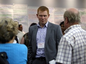 Dr. Andrew Leach speaks to guest during Alberta's Climate Change conference at Chateau Louis in Edmonton, Alberta on September 2, 2015. Perry Mah/Edmonton Sun/Postmedia Network