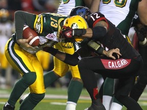 The Calgary Stampeders Juwan Simpson sacks Edmonton Eskimos QB Mike Reilly in second-half West Division Final action last November. (Darren Makowichuk, Postmedia Network)